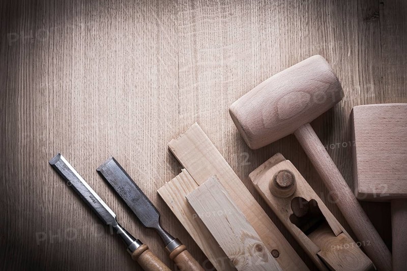Wooden planks hammers planner flat chisels on wood background construction concept