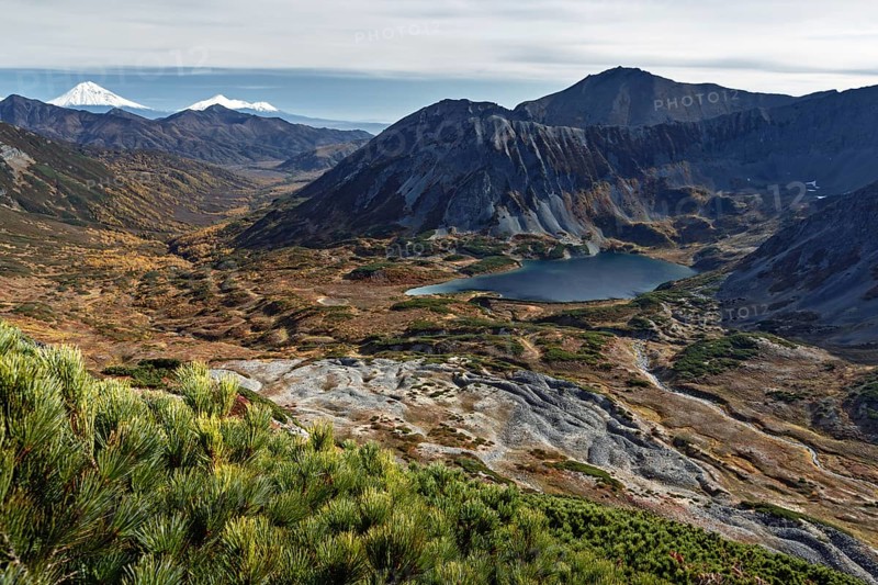 Beautiful autumn mountain landscape: picturesque view of mountains, lake and volcanoes. Far East, Russia, Kamchatka Peninsula, Europe
