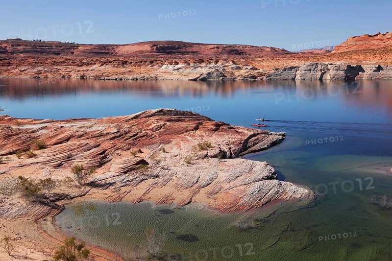 Antelope Canyon in the Navajo Reservation. Two boats with oars float near the water channel