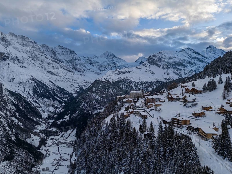 Murren Town and Mountains in Winter Evening. Swiss Alps. Switzerland. Aerial View