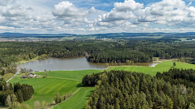 Green landscape with a lake, surrounded by forests and fields under a cloudy sky, Tirschenreuth, Upper Palatinate, Bavaria, Germany, Europe