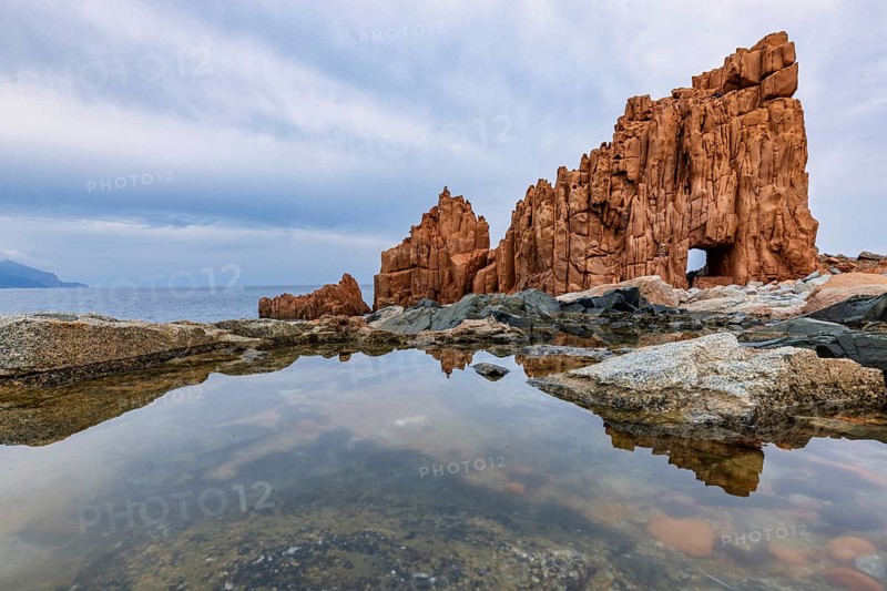 Rocce Rosse, the red rocks of Arbatax are reflected in a tidal pool, Arbatax, Tortoli, Ogliastra, Sardinia, Italy, Europe