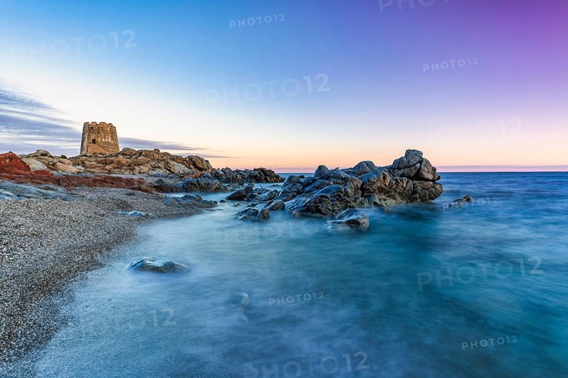 Old historic tower from the 16th century and rocks at sunset on the beach, long exposure, Torre di Bari, Barisardo, Ogliastra, Sardinia, Italy, Europe