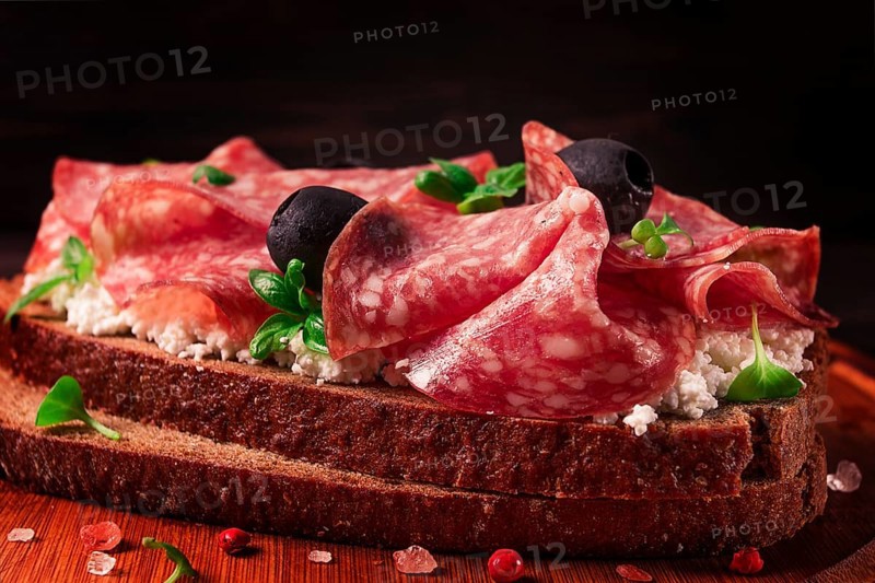Sandwich, grain bread, with cream cheese and salami, black olives, micro-greens, top view, close-up, no people, Breakfast