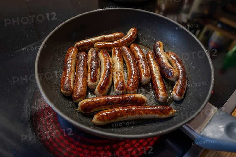 Nuremberg sausages in the pan on the cooker, Bavaria, Germany, Europe