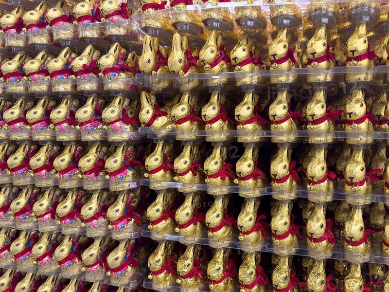 Display on shelf of retail wholesale of large number of chocolate Easter bunnies chocolate Easter bunnies chocolate Easter bunnies wrapped in golden gold-coloured staniol paper, Germany, Europe