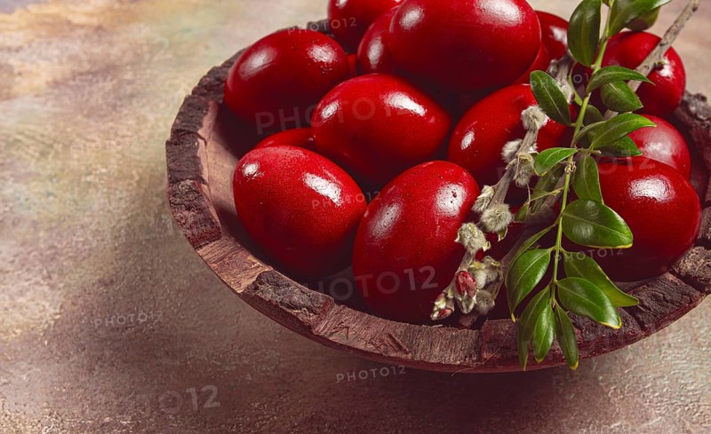 Painted eggs in a wooden bowl, red, painted madder dye, powder from the roots of endro, with onion husks, top view, Easter, Georgia, Asia