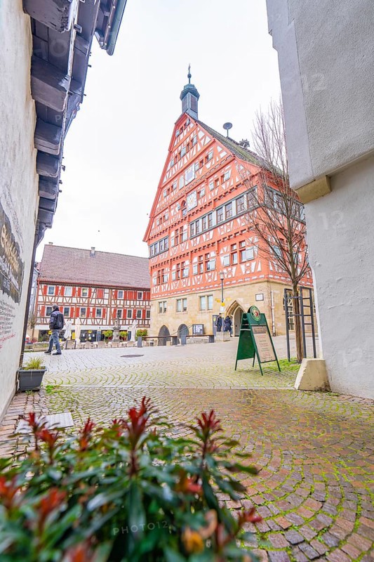 View of a red half-timbered house, town hall, through an alley with cobblestones, Großbottwar, Ludwigsburg district, Baden-Württemberg, Germany, Europe