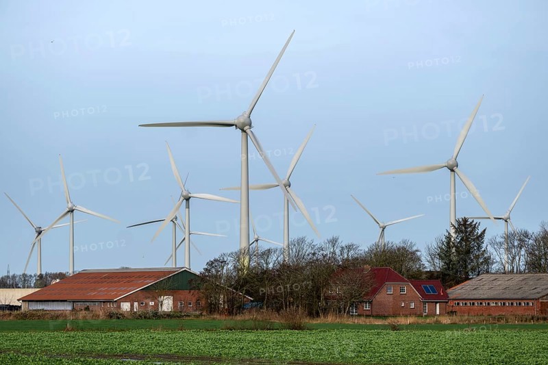 Norden, Lower Saxony, Germany - Wind turbines, wind farm near Norden in East Frisia. In front a farm with residential house