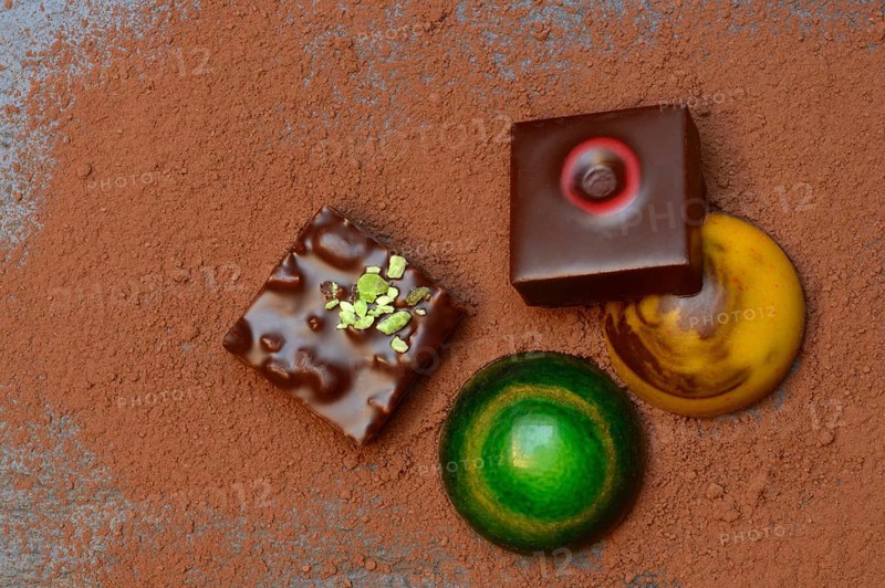 Colourful chocolates on cocoa powder