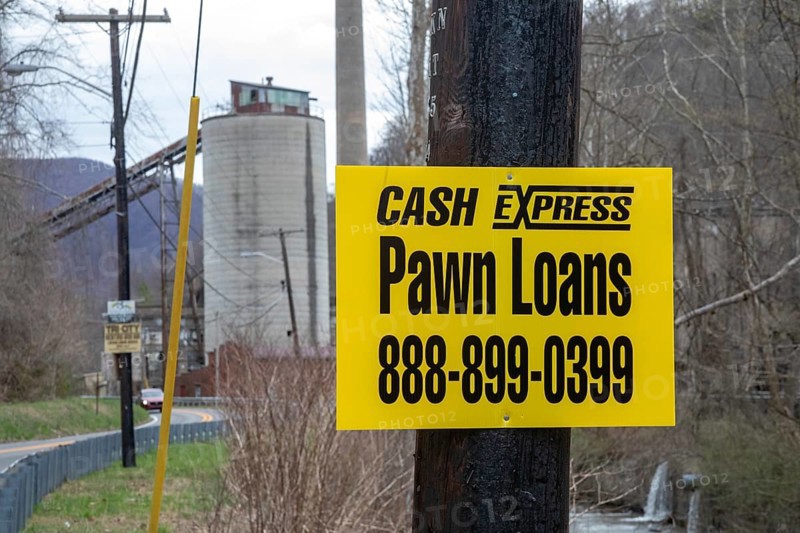 Lynch, Kentucky - A pawn shop advertises near coal mining equipment that remains in a former U.S. Steel company town in Harlan County. Automation and the subsequent closure of most mines have reduced the area's population and increased its poverty