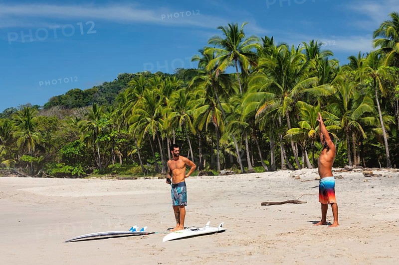Surfers warming up on the beach of Santa Teresa, Nicoya Peninsula, Guanacaste, Costa Rica, Central America