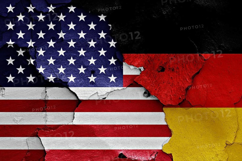 Flags of United States and Germany painted on cracked wall