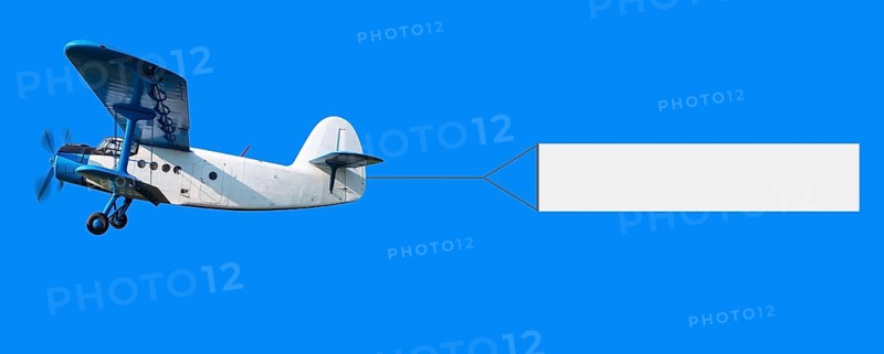 biplane with a banner in the sky