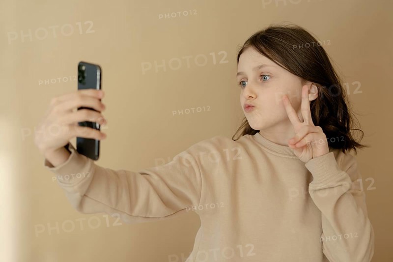 Girl, 10, takes a selfie with mobile phone