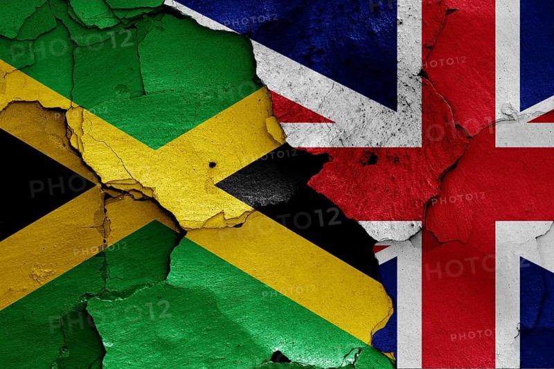 Flags of Jamaica and UK painted on cracked wall