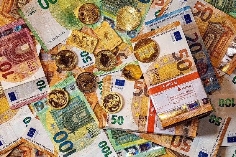 Gold and banknotes, euros and gold coins and gold bars, piles and bundles