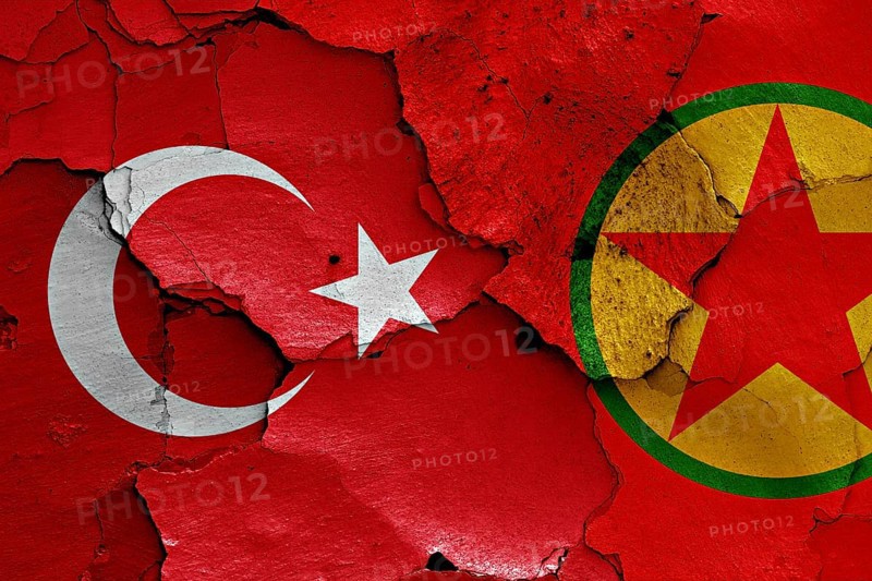 Flags of Turkey and PKK painted on cracked wall