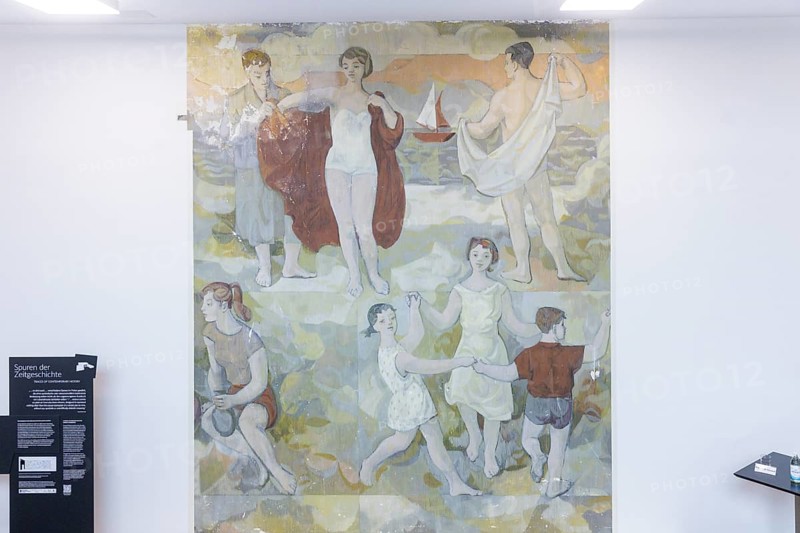 The partial uncovering of the early work in the Deutsches Hygiene-Museum has been completed In the south stairwell foyer of the Deutsches Hygiene-Museum, the large-format mural Lebensfreude (Joy of Life) was created in 1956, with which the then 24-year-old Gerhard Richter completed his studies at the Dresden Academy of Fine Arts. This diploma work, measuring around 63 square metres, was painted over in 1979 and then largely forgotten. After two smaller windows had already been opened in the 1990s, a central section of this historically significant work of art has been uncovered since February 2024 with Gerhard Richter's consent. The result of this complex restoration project can now be viewed. The uncovering was a joint project of the Deutsches Hygiene Museum and the Wüstenrot Foundation in co-operation with the Dresden University of Fine Arts. The accompanying educational measures were supported by the Ernst von Siemens Art Foundation through a