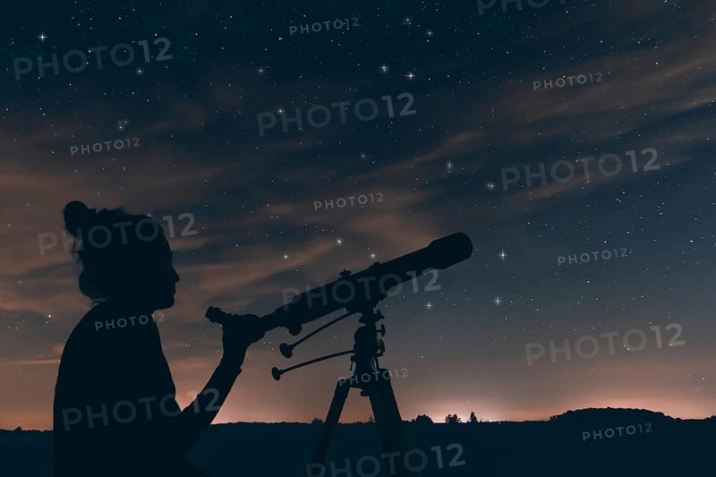 Woman with astronomical telescope. Night sky, with clouds and constellations, Hercules, Draco, Ursa Major, Ursa Minor, Big Dipper, Botes