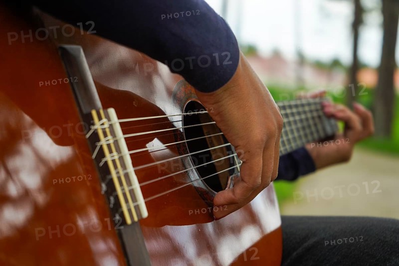 Playing Guitar in Green Park. Guitar Body. Close-Up Shot