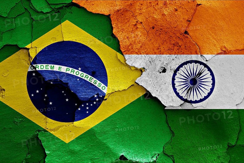 Flags of Brazil and India painted on cracked wall