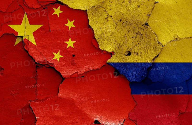 Flags of China and Colombia painted on cracked wall