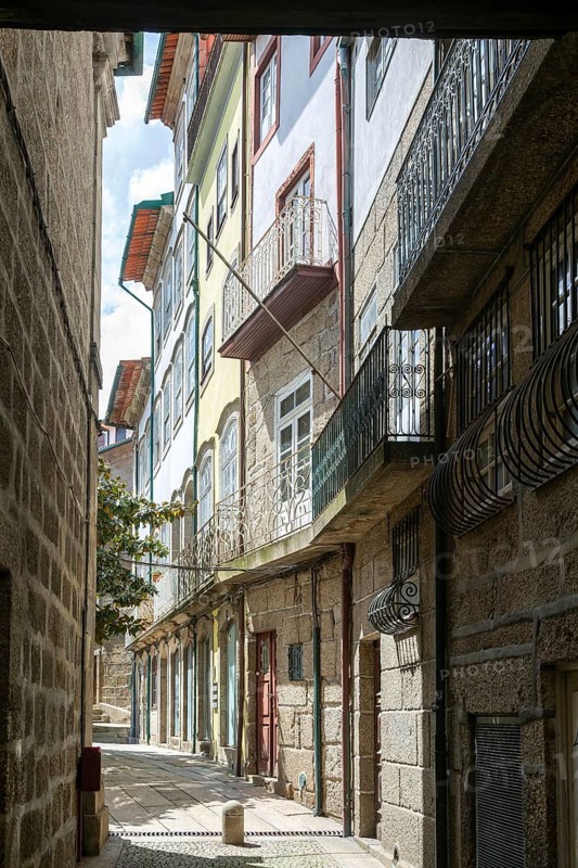 Street of historic buildings with balconies, city centre Guimaraes, northern Portugal