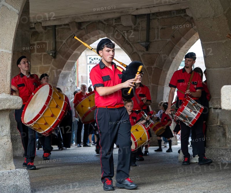 Traditional drum and pipe band perform on city streets on May Day 2025, Guimaraes, Braga district, northern Portugal