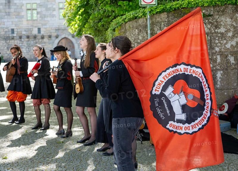 Group female university students musicians perform in street, city of Guimaraes, northern Portugal