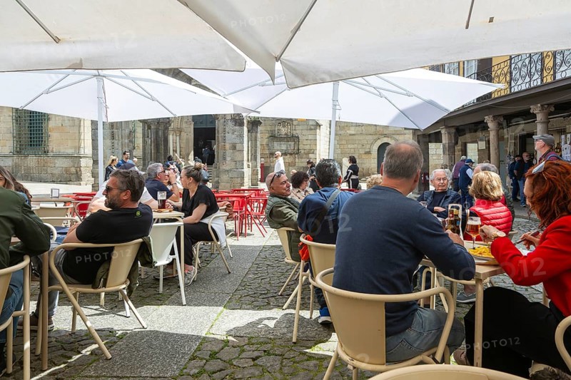 Customers sittimg outside at cafe tables, Largo da Oliveira square, city of Guimaraes, northern Portugal
