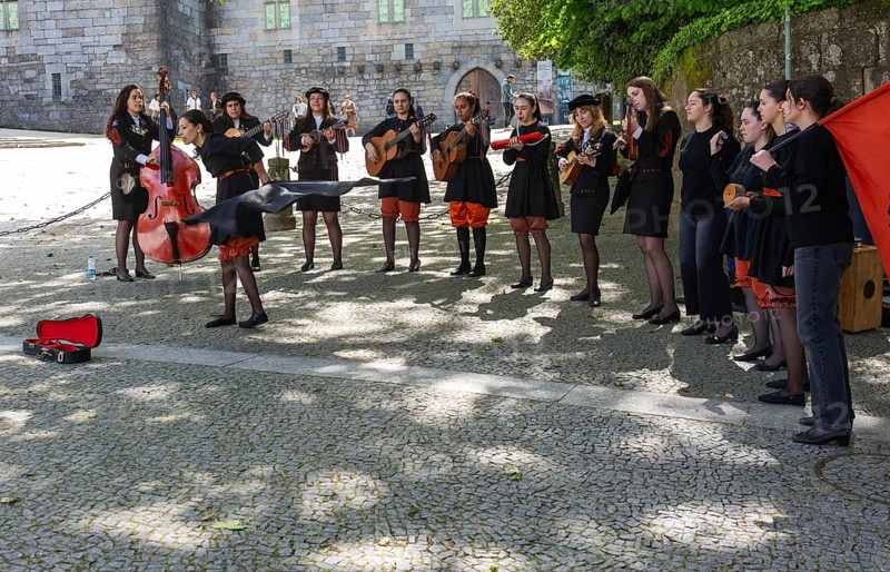 Group female university students musicians perform in street, city of Guimaraes, northern Portugal