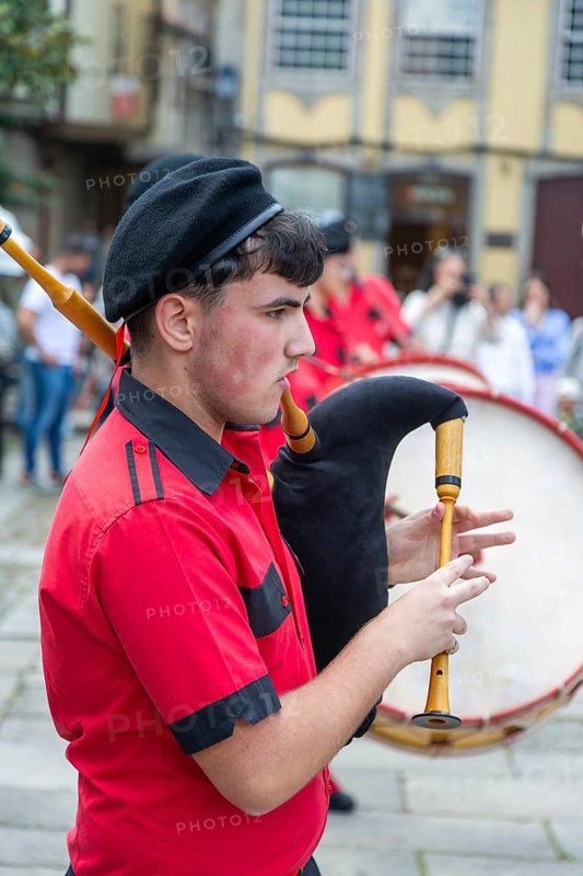 Traditional piper in band performing on city streets on May Day 2025, Guimaraes, Braga district, northern Portugal