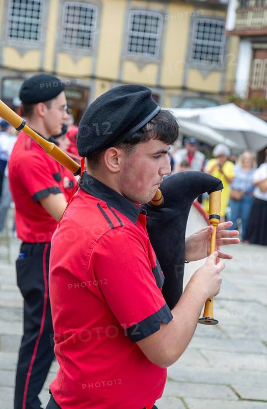 Traditional piper in band performing on city streets on May Day 2025, Guimaraes, Braga district, northern Portugal