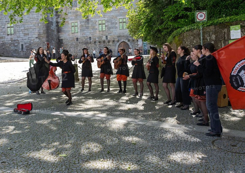 Group female university students musicians perform in street, city of Guimaraes, northern Portugal