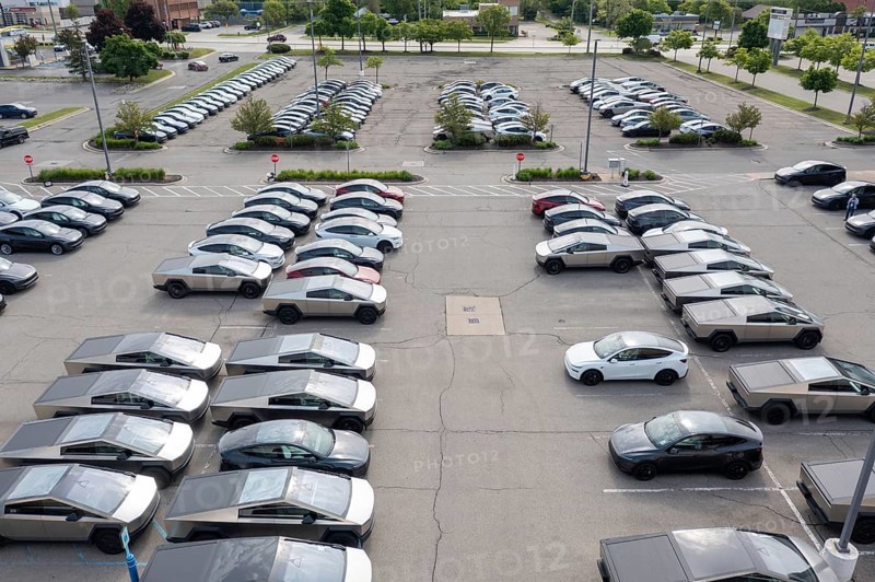 Farmington Hills, Michigan USA - 30 May 2025 - Many dozens of unsold Tesla electric vehicles, including Cybertrucks, are stored in the parking lot of a closed shopping center in suburban Detroit. Tesla sales have fallen in 2025, at least partly in response to CEO Elon Musk's political activity in the Trump Administration