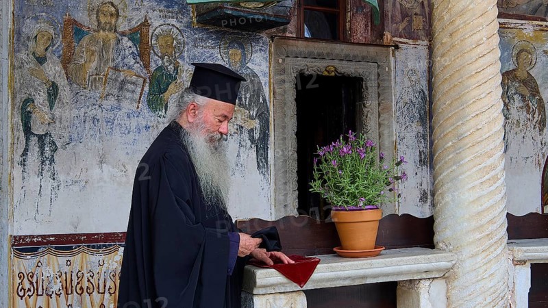 Priest with traditional robe in an interior with mural painting, Monastery of St John the Theologian, Monastery of St John the Theologian, World Heritage Site 1999, Patmos, Dodecanese, Greek Islands, Greece, Europe