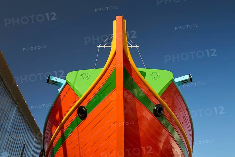 Close-up of the bow of a large orange boat in front of a clear sky, Diakofti boatyard, new construction of a coloured wooden boat, Diakofti, Patmos, Dodecanese, Greek Islands, Greece, Europe