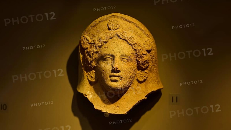 Ancient stone head of a goddess, exhibited in a museum-like setting, found in the cave of Aspri Petra, Archaeological Museum, Kos Town, Kos, Dodecanese, Greek Islands, Greece, Europe