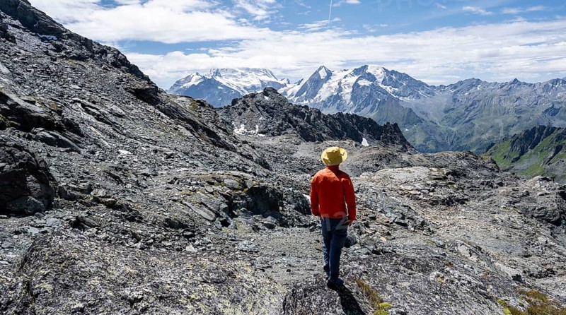 Mountaineer in rocky mountain landscape at the Col du Louvie, view of the summit of the Grand Combine, Valais Alps, Val de Bagnes, Valais, Switzerland, Europe