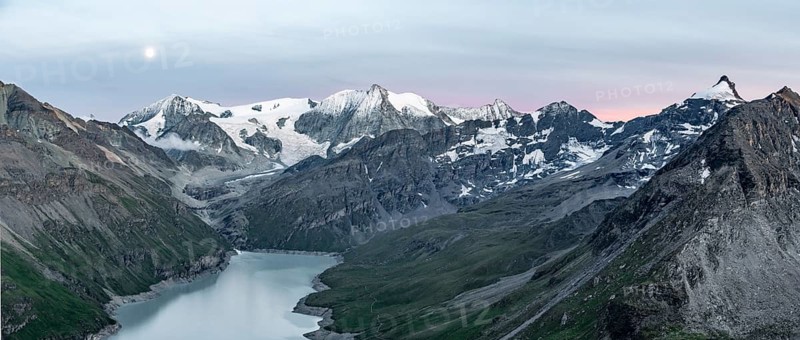 Mountain landscape with turquoise blue reservoir Lac des Dix and summit Mont Blanc de Cheilon, moon above mountain peaks at sunset, Hérménence, Valais Alps, Valais, Switzerland, Europe