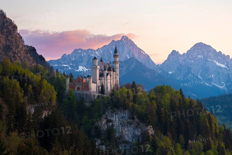 Neuschwanstein Castle after sunset with mountain landscape in the background, Schwangau near Füssen, Ostallgäu district, Swabia, Bavaria, Germany, Europe