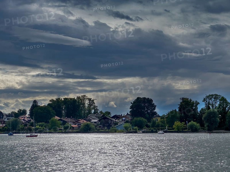 Dark clouds over Lake Chiemsee, view of the island of Frauenchiemsee, Bavaria, Germany, Europe