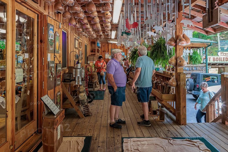 Senior men on the front porch of Bearmeats Indian Den arts, crafts and souvenir shop in Cherokee, North Carolina