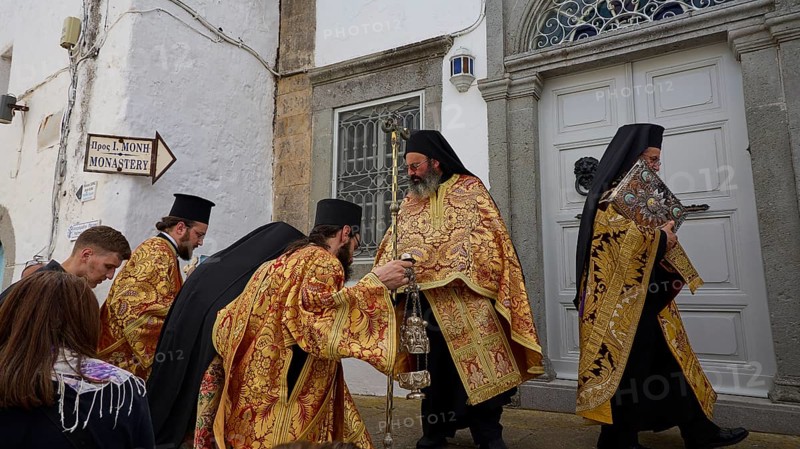 Priests in gold and black robes enter a door during a procession, Orthodox ceremony, monks of St John's Monastery, ceremonial washing of feet, procession, Maundy Thursday, Megali Pempti, Chora, Patmos, Dodecanese, Greek Islands, Greece, Europe