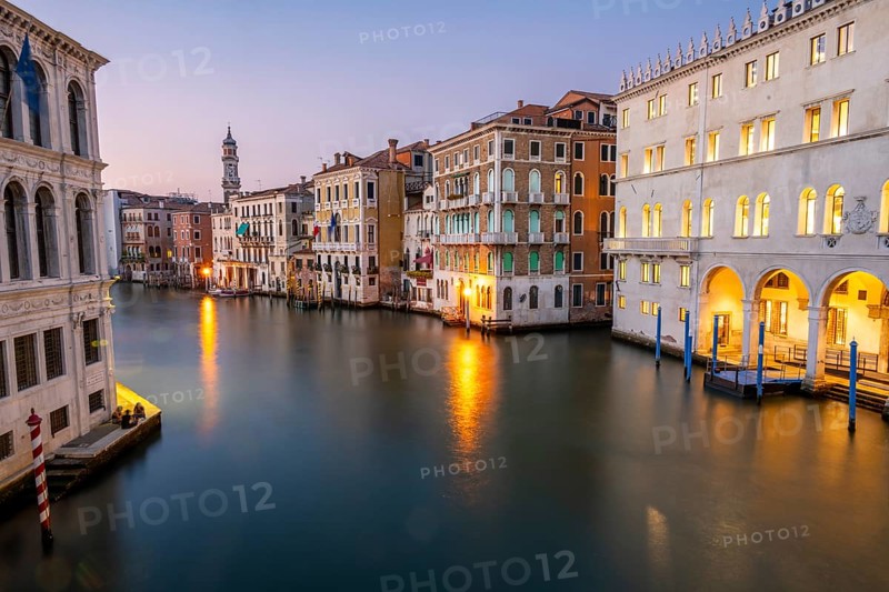 View of the Grand Canal at sunset, picturesque evening mood with illuminated palazzos on the canal and the church tower of the Chiesa Parrocchiale dei Santi Apostoli, long exposure, view from the Rialto Bridge, Venice, Veneto, Italy, Europe