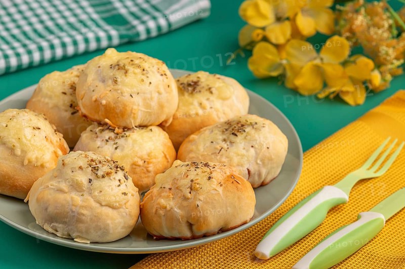 Baked pizza, balls on a plate with decoration and cutlery