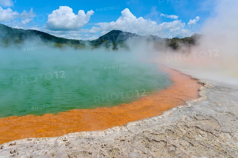 Bubbling mineral spring with steam and surrounded by mountains, Champagne Pool thermal lake, Wai-O-Tapu Thermal Wonderland, Rotorua, North Island, New Zealand, Oceania