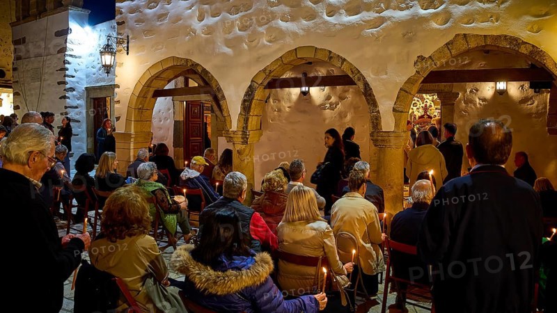 Good Friday, Church of Agios Ioannis Prodromos, worshippers, gathering of people with candles in front of a traditional building at night, Skala, harbour, Patmos, Dodecanese, Greek Islands, Greece, Europe