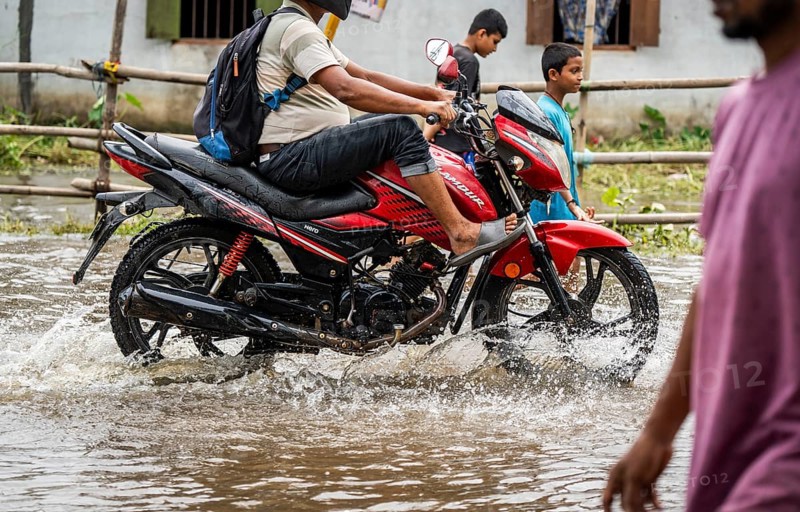 Commuters passing through a waterlogged street following heavy rainfall in Guwahati, India, on 1 June 2025, Asia